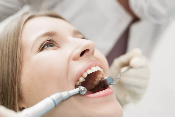 Woman with mouth open at dentist's office